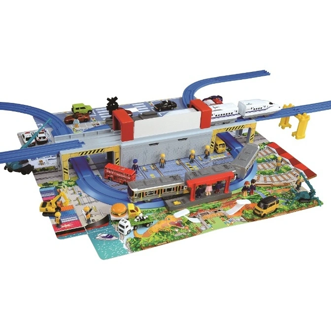  Toy train set with elevated tracks, station, vehicles, and miniature figures on a play mat.