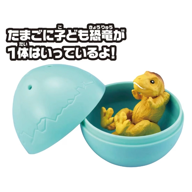  Toy dinosaur hatching from a blue egg.