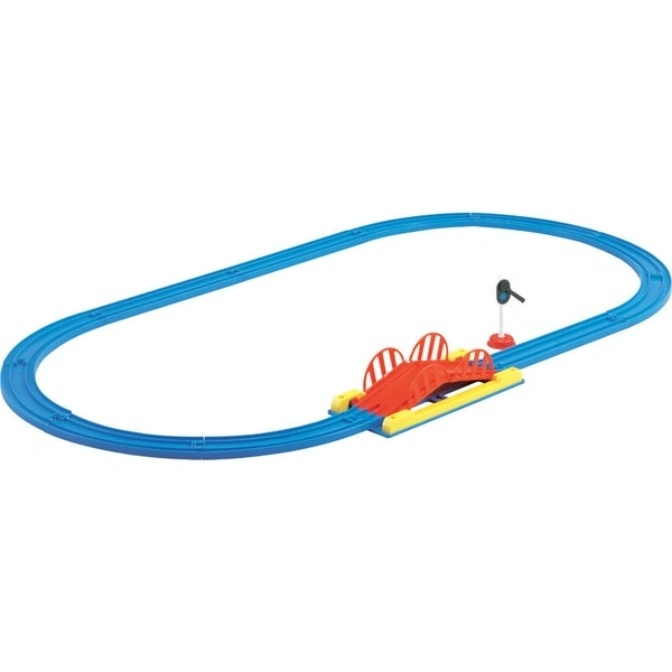 Blue toy train track forms an oval with a red bridge and a black signal light.