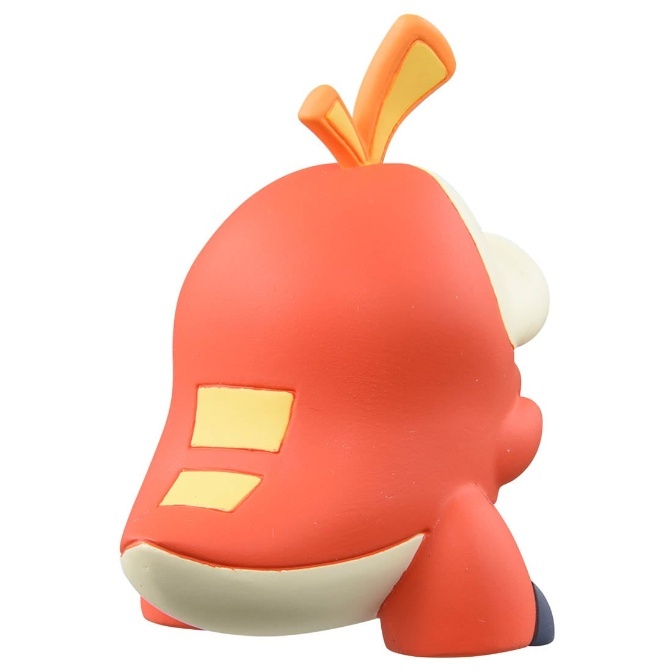 Fuecoco toy figure, rear view. Orange body with cream underbelly and yellow accents.